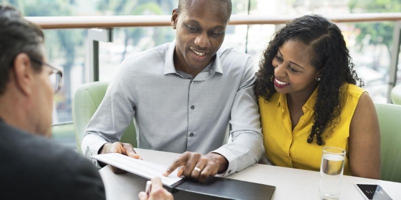 Business owners discussing small business loan application with funding advisor