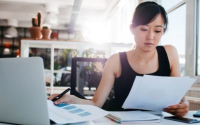 business woman reviewing files at desk