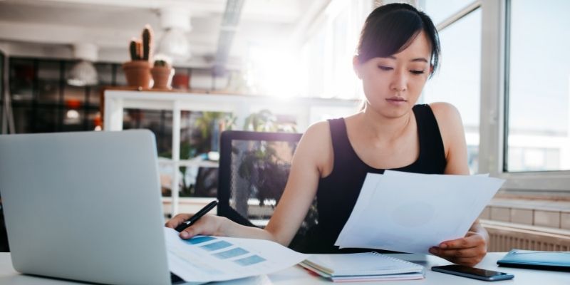 business woman reviewing files at desk