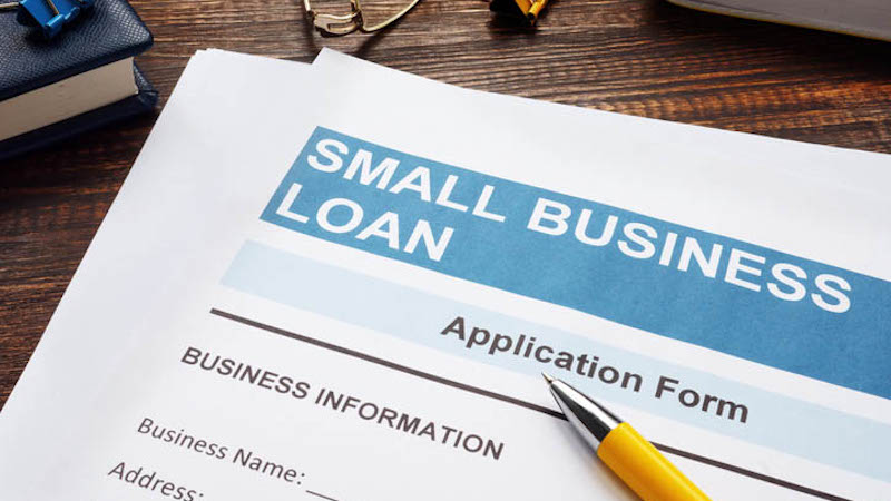 small business loan application on the wooden surface and papers.